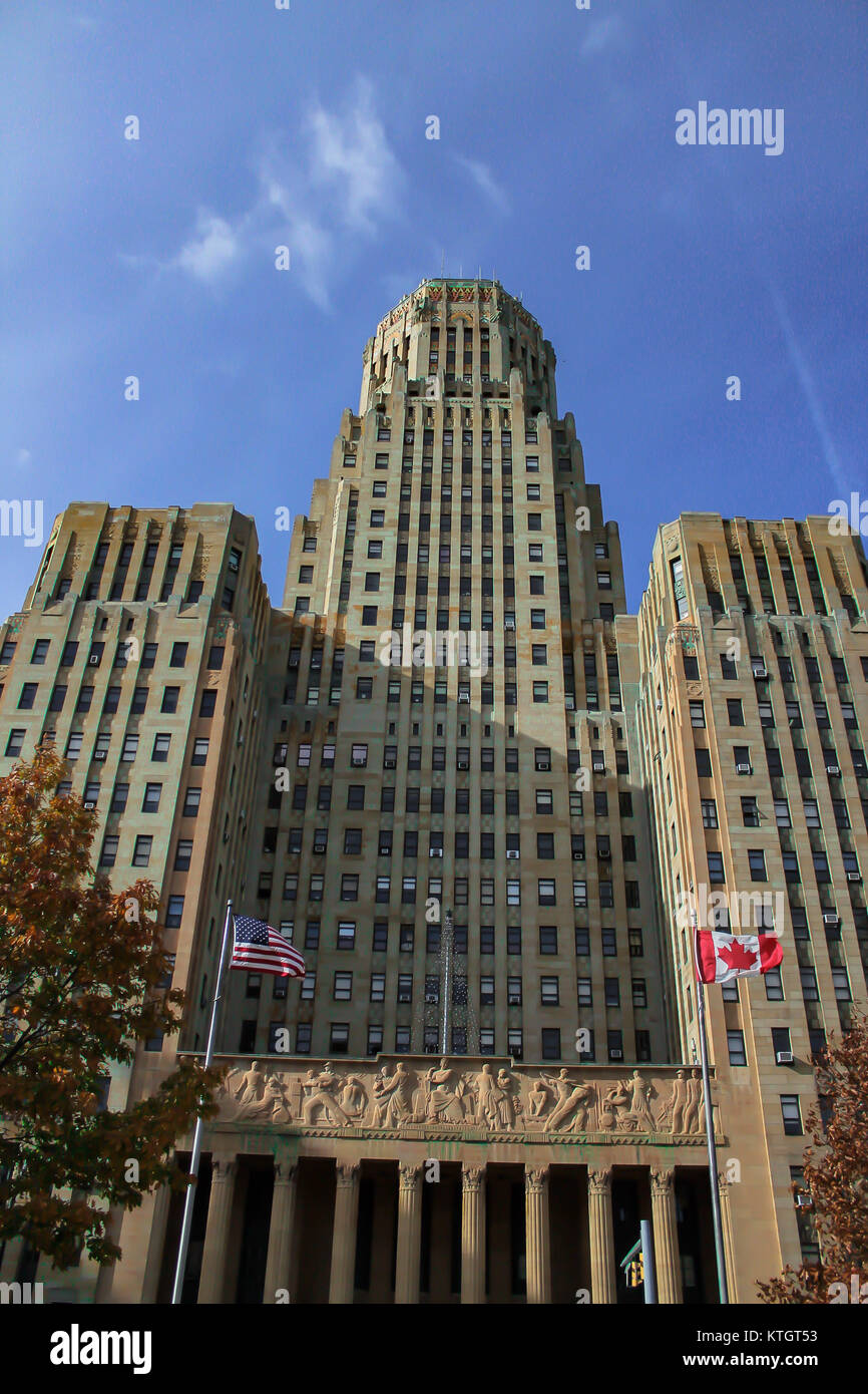 Buffalo City Hall in the day with blue semi cloudless sky and American and Canadian flags flying in the foreground in Buffalo, New York in Erie County Stock Photo