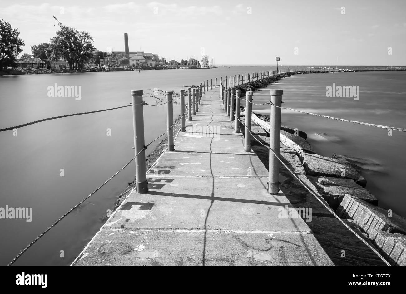 Black and white long exposure concrete trail on Bird Island Pier in Niagara River adjacent to Lake Erie in Buffalo, New York in Erie County Stock Photo