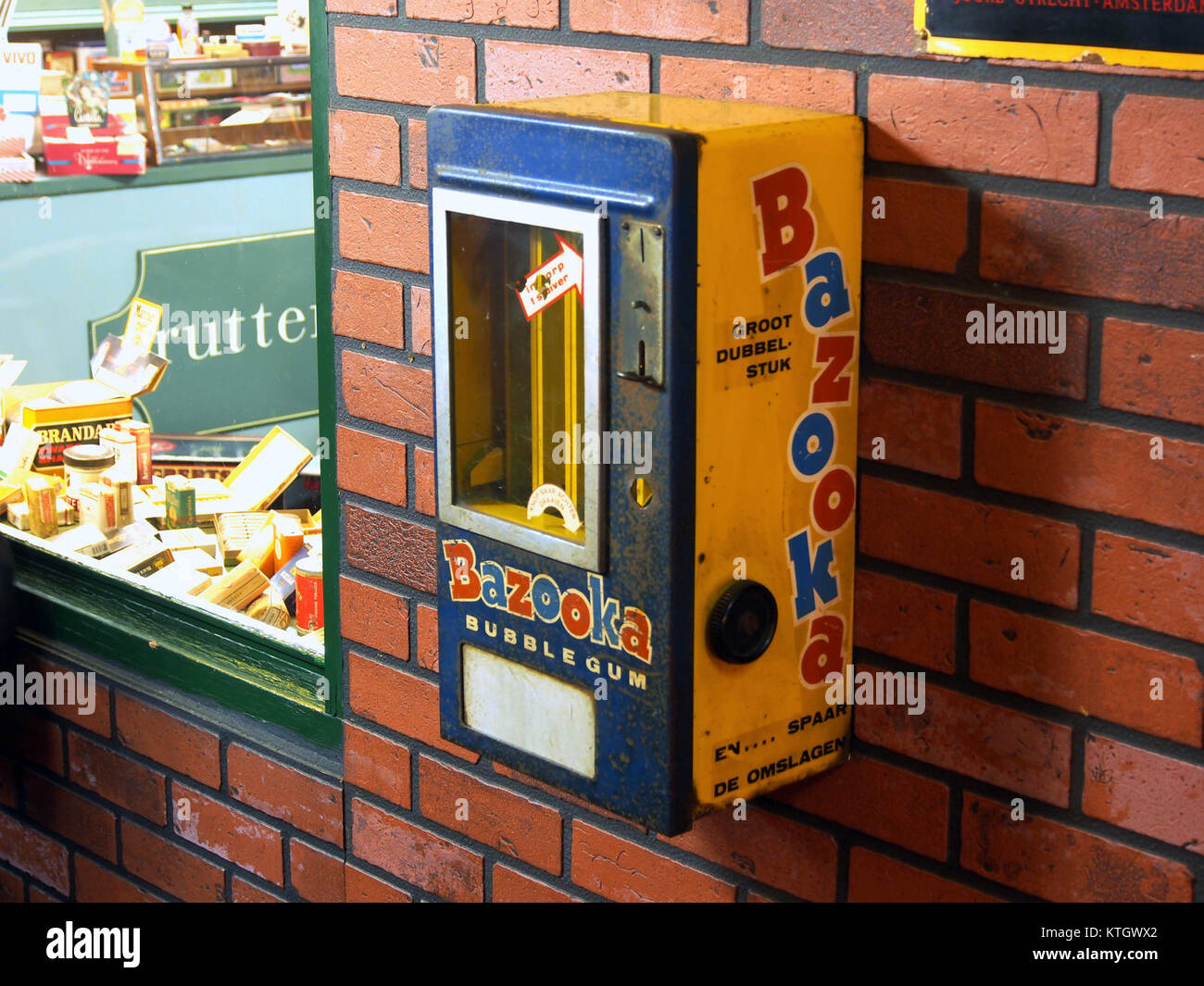 The Bazooka vending machine is a retro, mechanical device that dispenses chewing gum, primarily featuring Bazooka brand gum, from the mid-20th century. Stock Photo