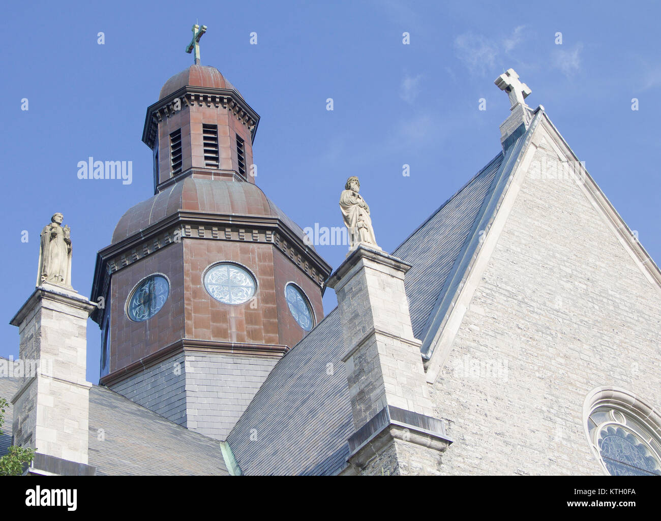Exterior daytime steeple and statues atop Church of St. Stanislaus