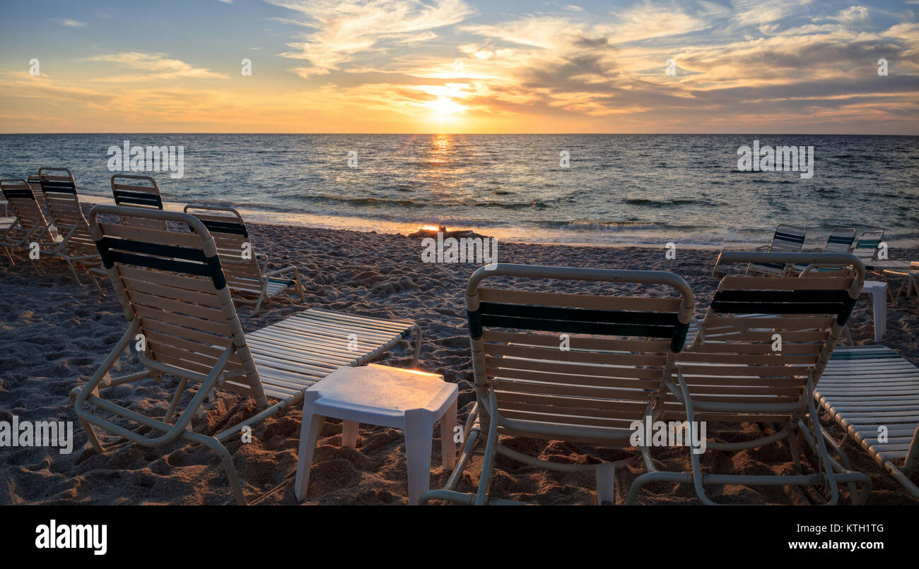 Chairs along Vanderbilt Beach in Naples, Florida, USA at sunset Stock Photo