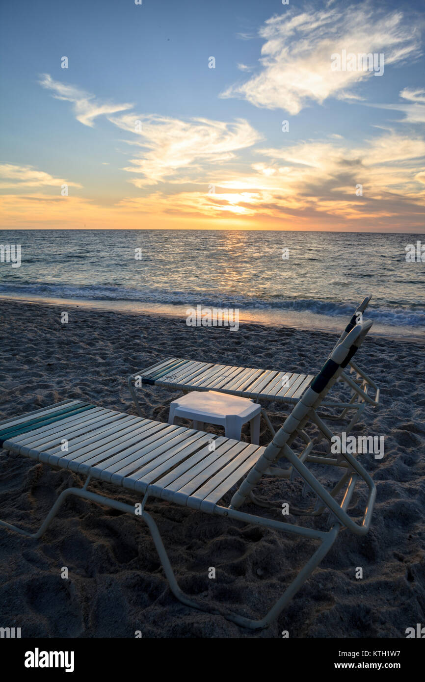 Chairs along Vanderbilt Beach in Naples, Florida, USA at sunset Stock Photo