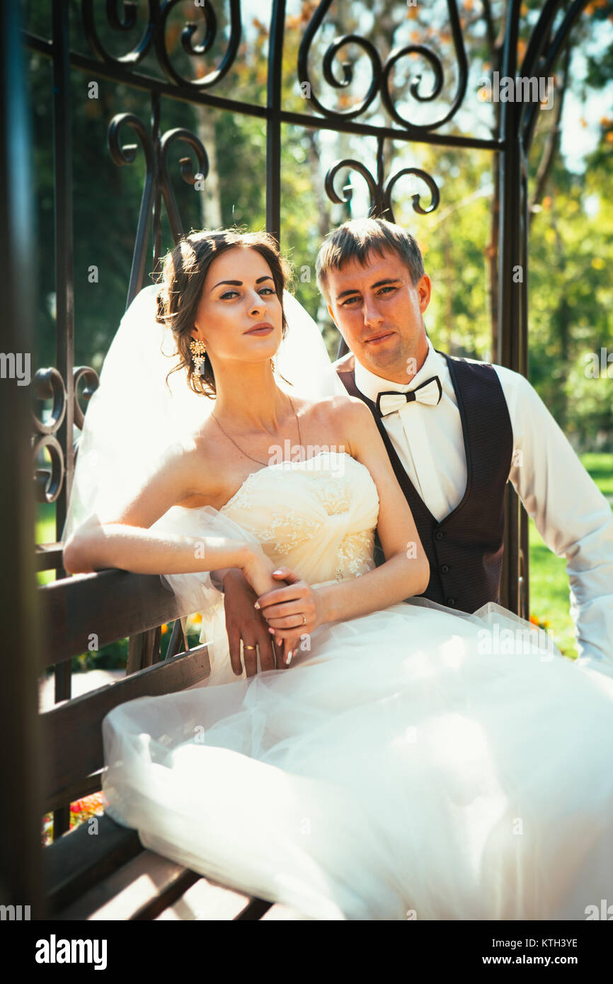 the bride and groom in the gazebo in the park Stock Photo - Alamy