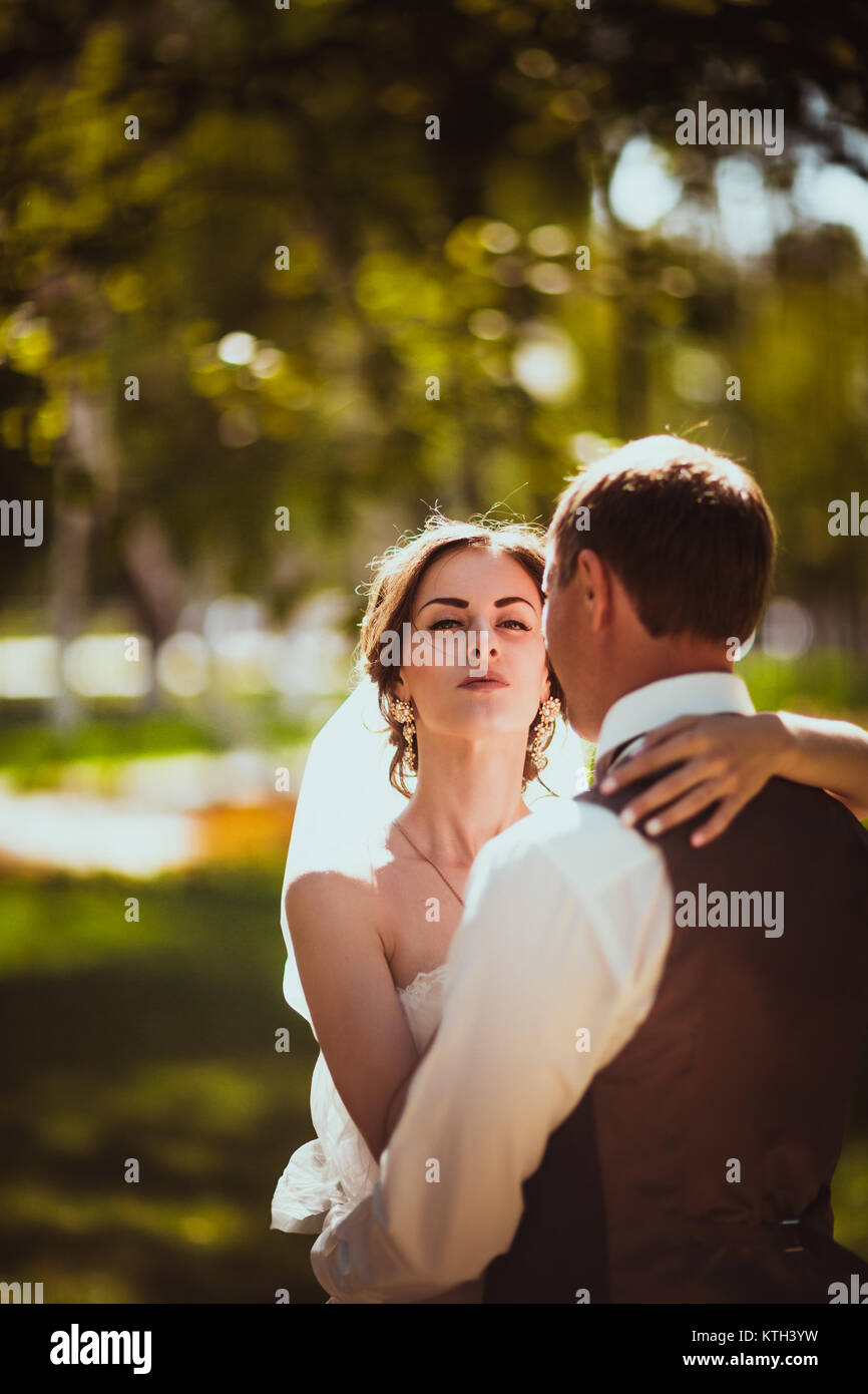The bride and groom in the background of the park Stock Photo - Alamy