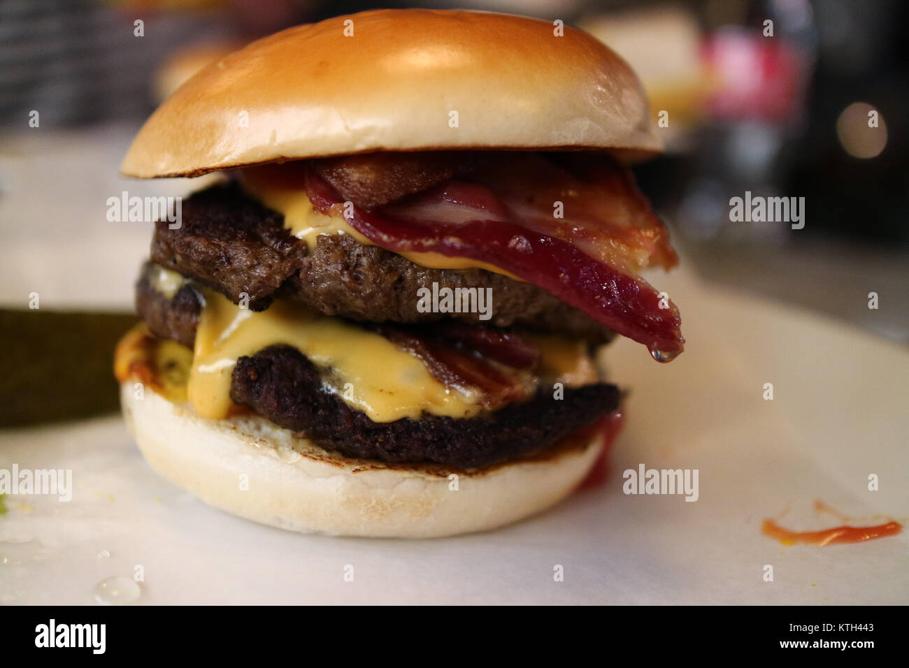A juicy double cheese burger with bacon Stock Photo Alamy
