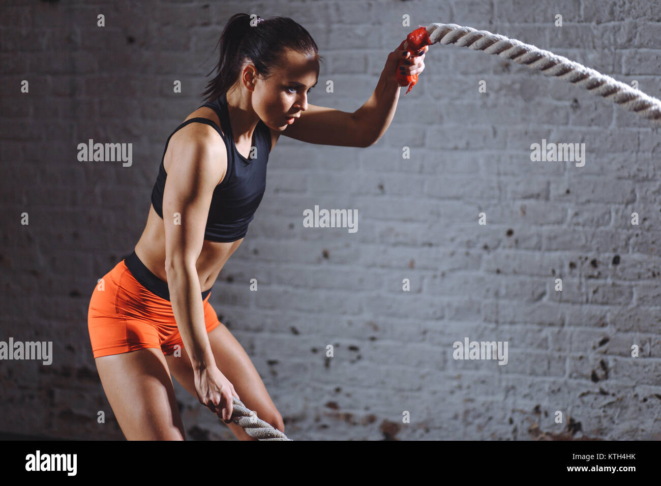 Woman Crossing Rope Woman training battling rope in hi-res stock photography and images - Alamy