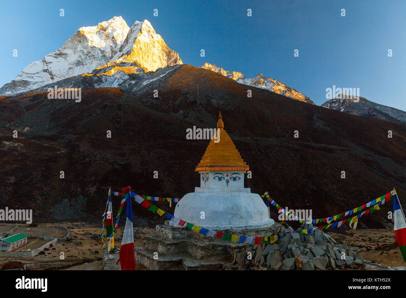Buddhist stupa on mountain trekking path in Himalayas, Nepal. Stock Photo