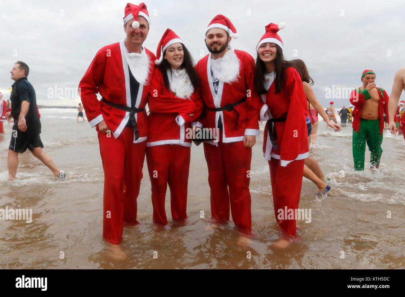 People in Santa outfits Stock Photo