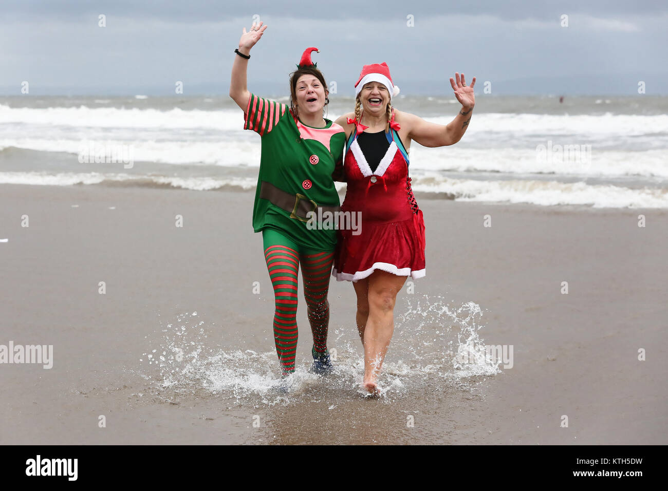 Two women in an elf and a Santa fancy dress Stock Photo