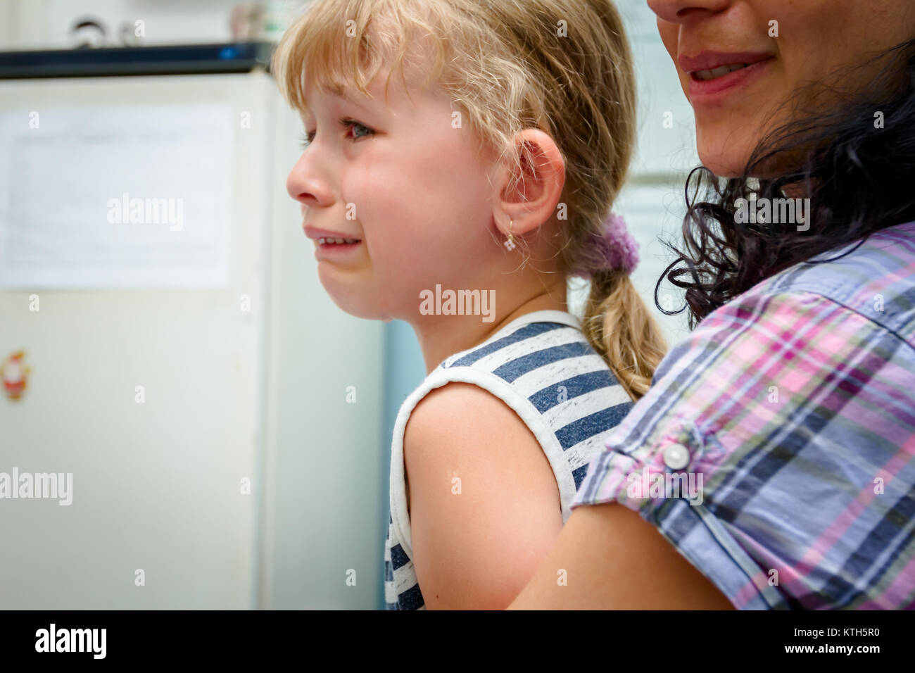 Preschooler child is cry after she has received vaccine, injection at doctor's office. Stock Photo