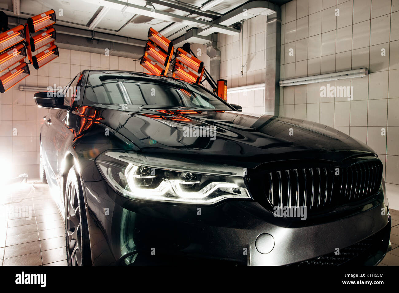 lamps for drying the ceramic coating are behind car Stock Photo Alamy