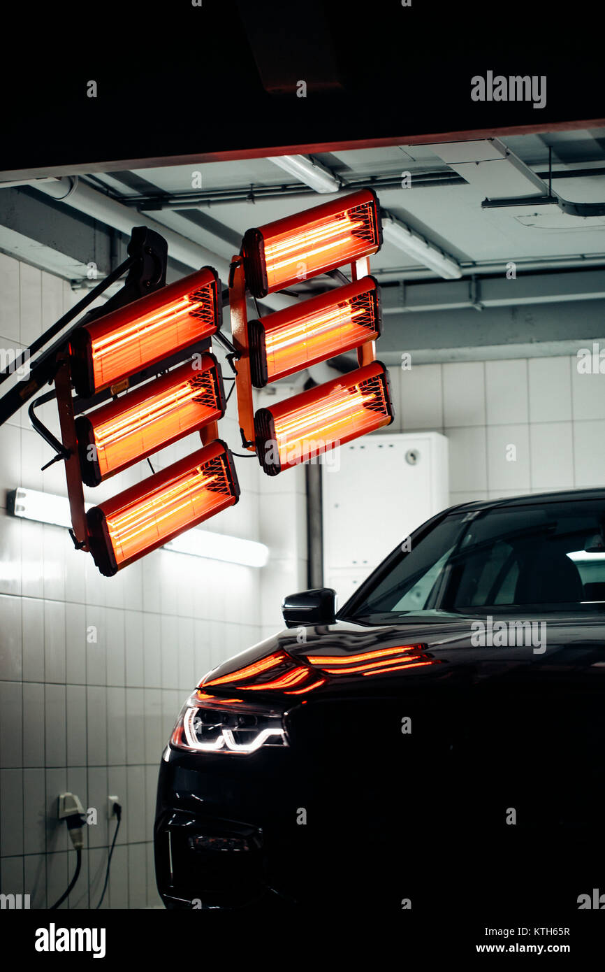 lamps for drying the ceramic coating are behind car Stock Photo Alamy