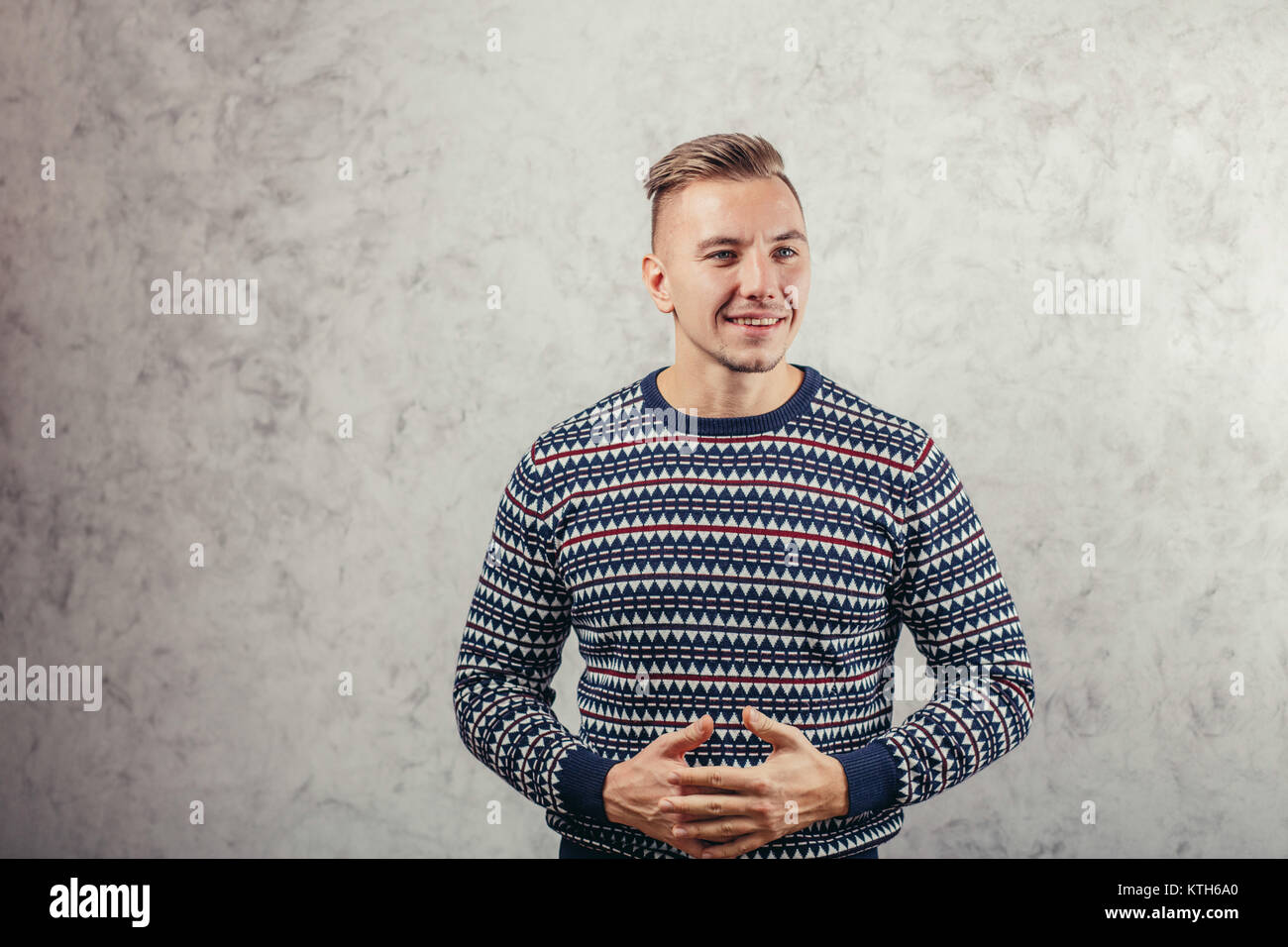 man leaning against a concrete wall and thinking Stock Photo - Alamy