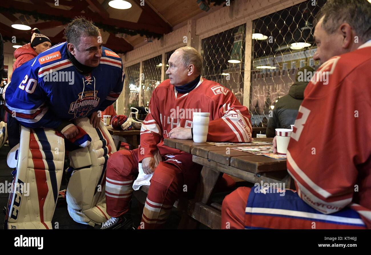 Russian President Vladimir Putin, center, chats with Tula Region Governor Alexei Dyumin, left, as Defence Minister Sergei Shoigu, right, looks on during intermission at a Night Ice Hockey League match in Red Square December 23, 2017 in Moscow, Russia. Stock Photo