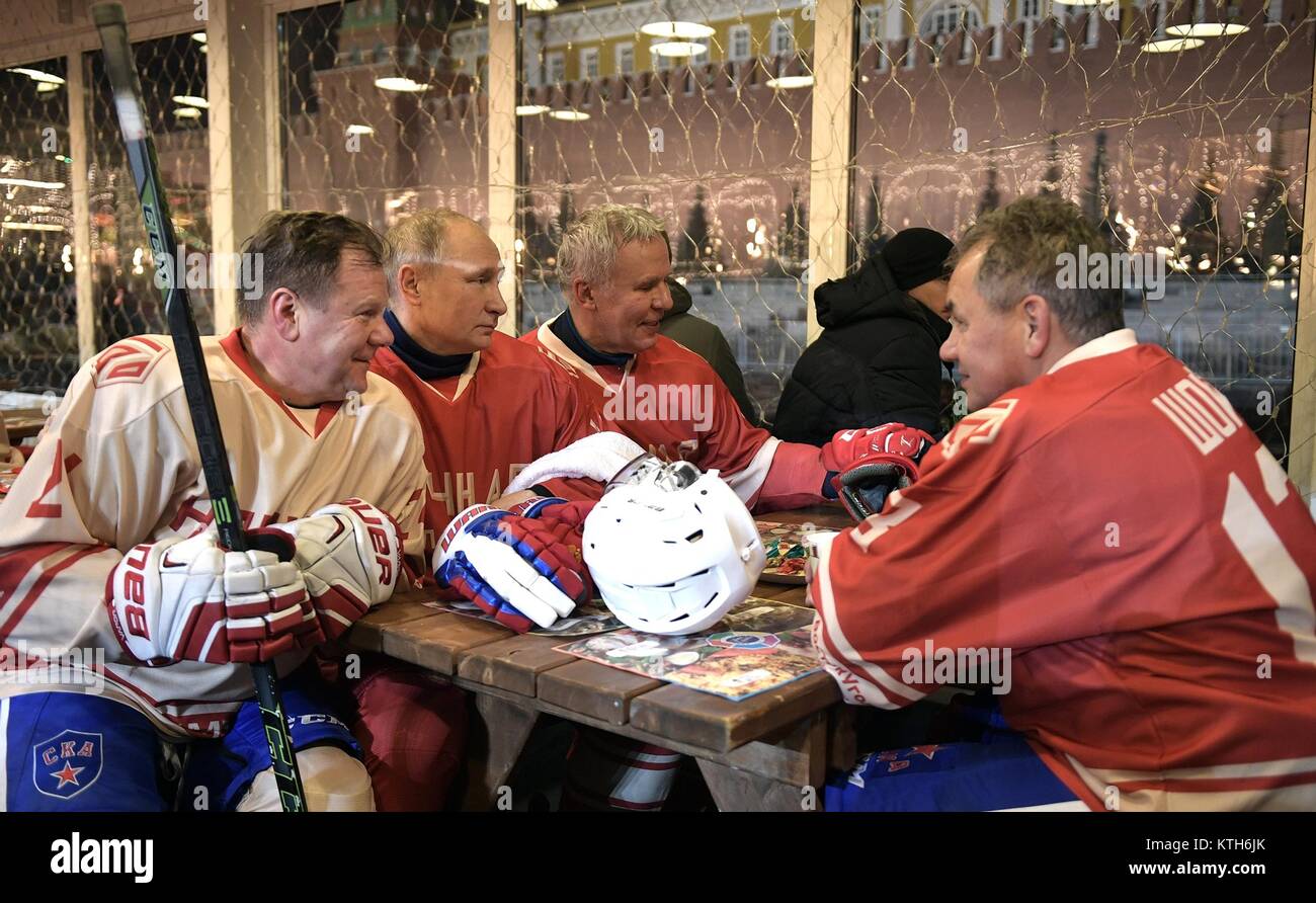 Russian President Vladimir Putin, center, chats with Tula Region Governor Alexei Dyumin, left, and Defence Minister Sergei Shoigu, right, during intermission at a Night Ice Hockey League match in Red Square December 23, 2017 in Moscow, Russia. Stock Photo