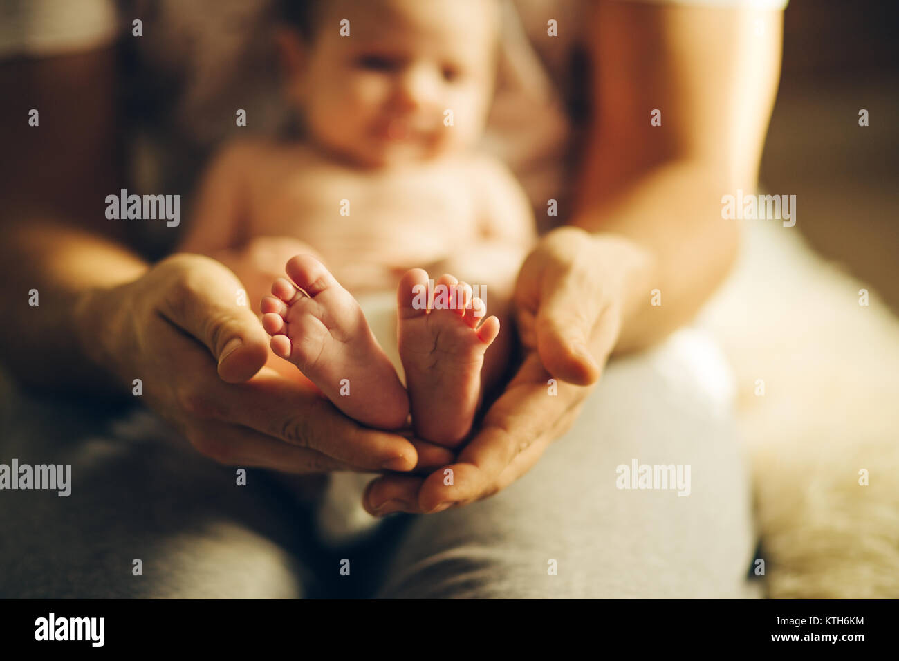 Baby feet in mother hands. Newborn Baby's feet on hands Stock Photo