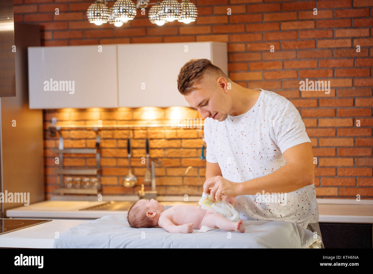 father is changing nappy to his baby boy Stock Photo Alamy