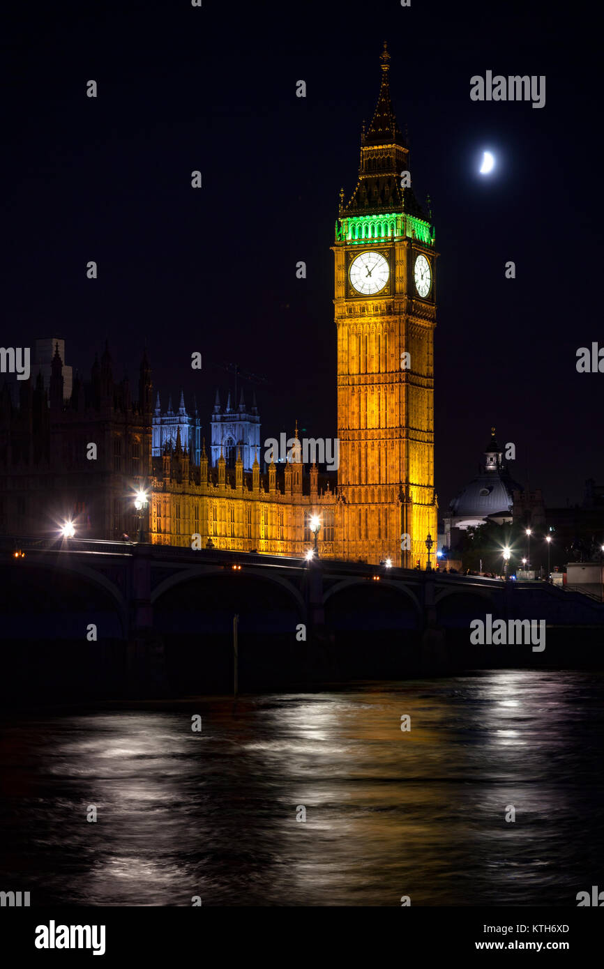 London cityscape with illuminated Elizabeth Tower aka Big Ben and the Westminster Bridge over the River Thames  at night Stock Photo