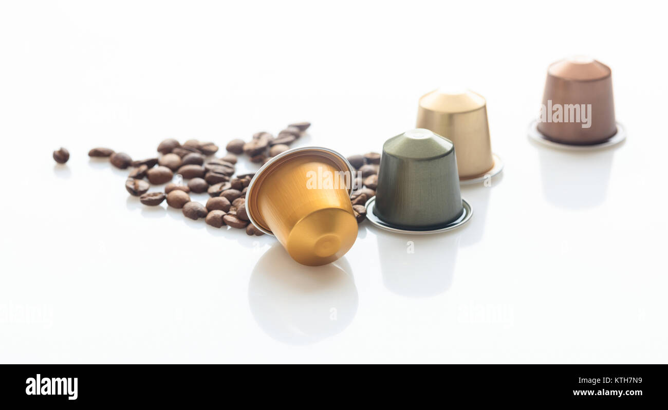 Espresso coffee capsules and coffee beans on white background, Closeup view with details Stock Photo