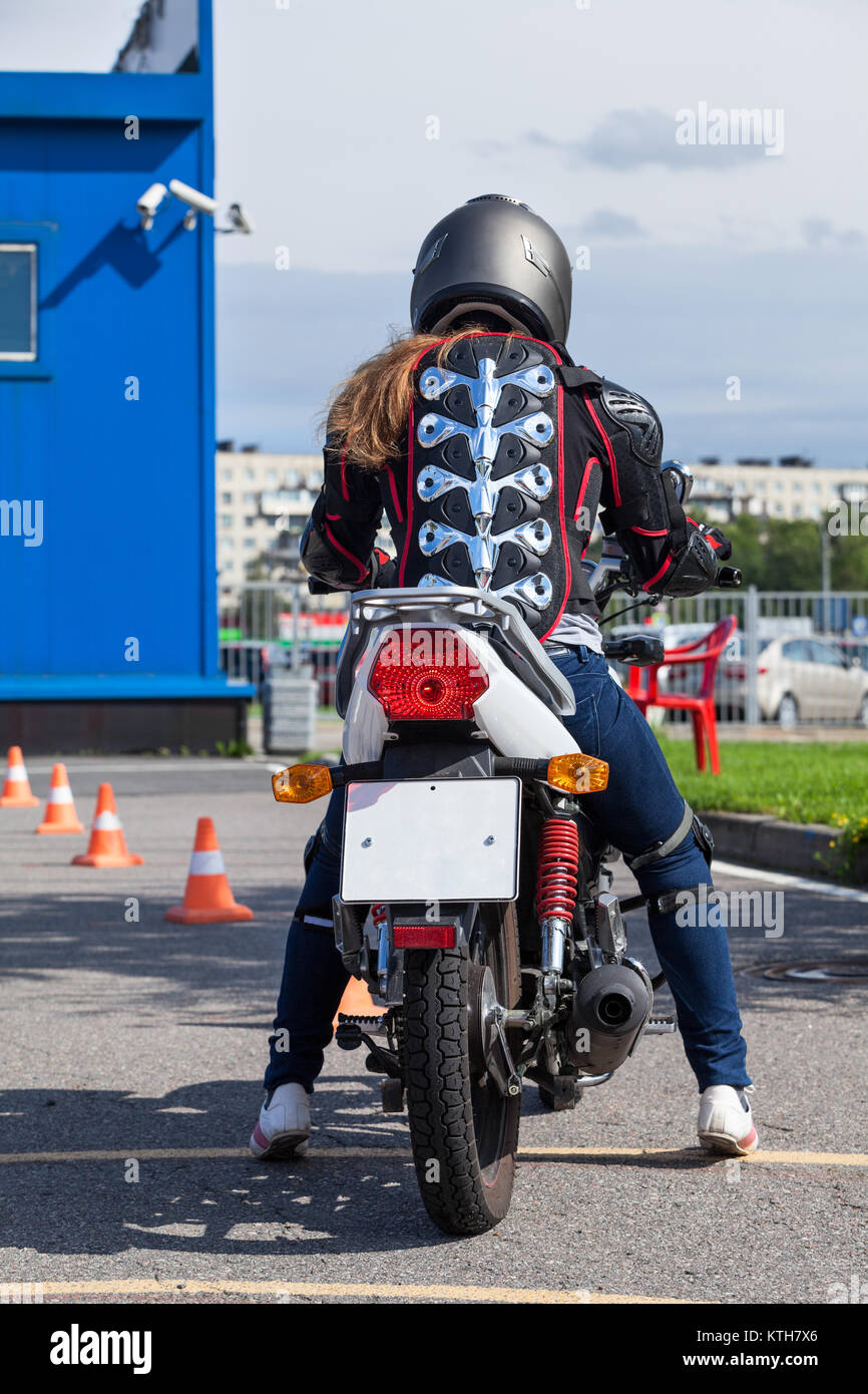 Woman L-driver is ready for driving slalom on training ground on motorbike,  rear view Stock Photo - Alamy