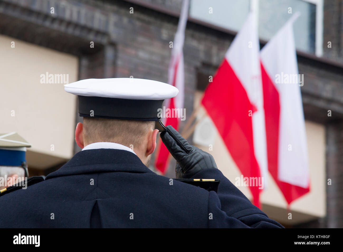 Polish Navy officer salute to Polish flag in Gdynia, Poland. 16th Dec
