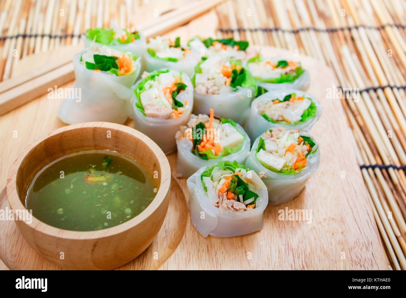 Fresh vegetable noodle spring roll with spicy sauce, thai style. Stock Photo