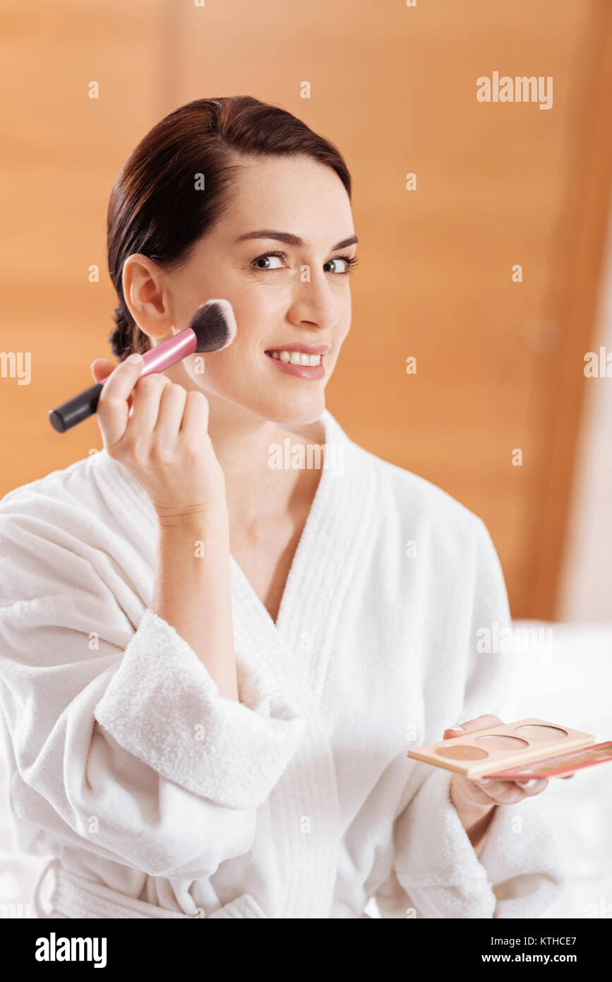 Happy pretty woman putting maquillage Stock Photo