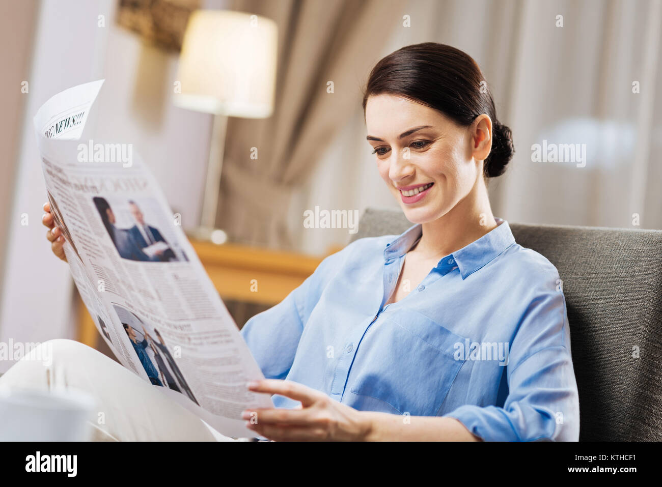 Joyful merry woman emerged into reading Stock Photo