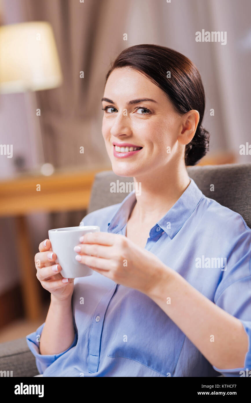 Brunette attractive woman smiling with coffee Stock Photo