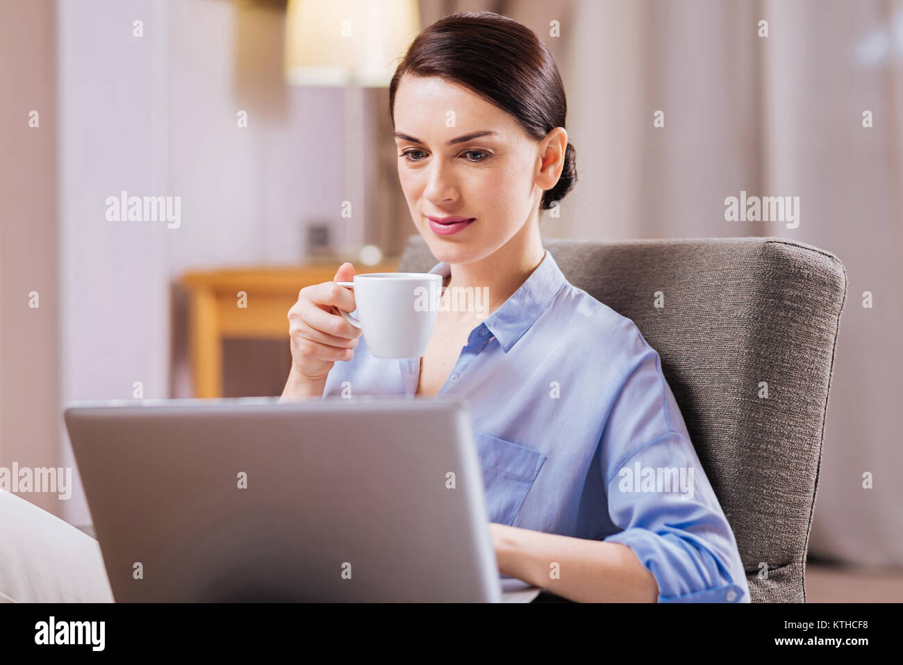 Budding attractive woman working with cup of tea  Stock Photo