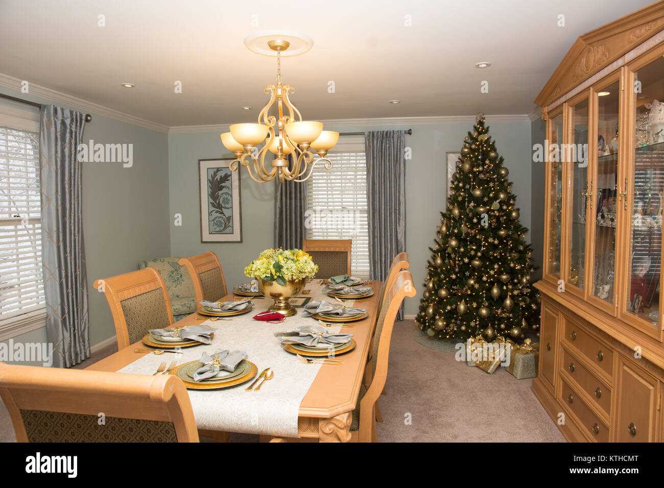 A formal dining room with table set, decorated for the Christmas holiday Stock Photo