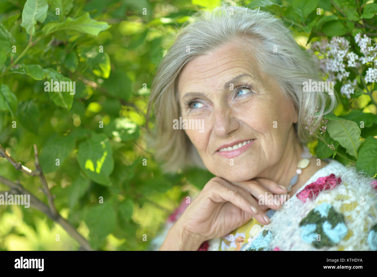 senior beautiful   woman posing in summer park Stock Photo