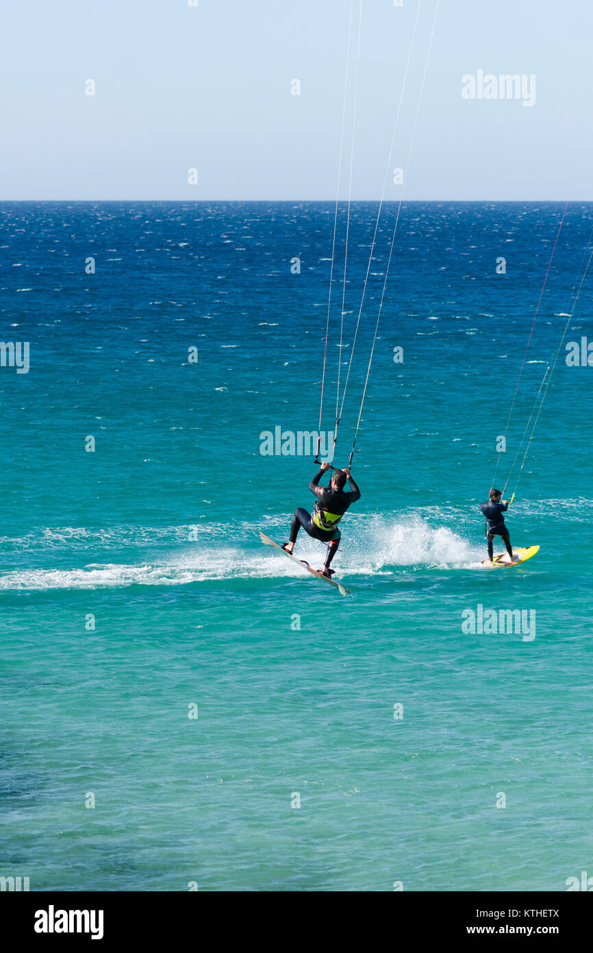 Kitesurfer, jump, jumping, wave riding, kitesurf ride waves in Tarifa, Andalusia, Spain. Stock Photo