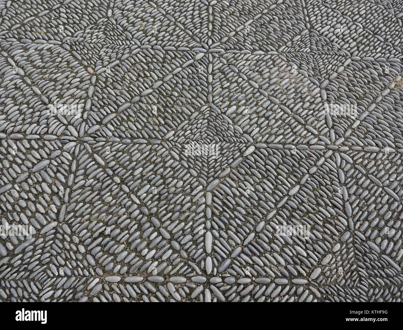 stone mosaic pavement, beautiful cobble stone sidewalk  - Stock Photo