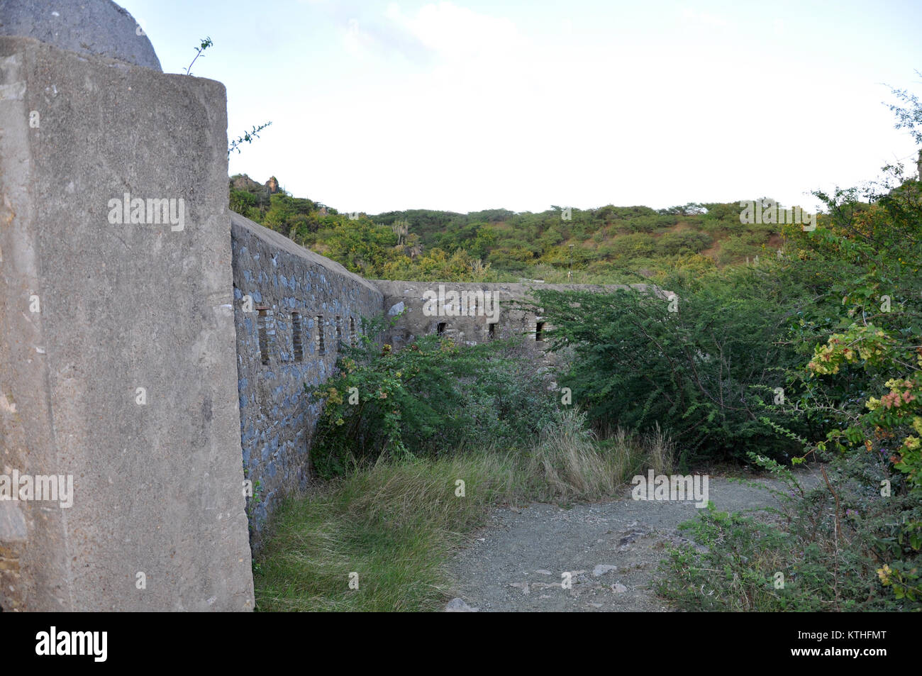 Remains of a wall at Fort Beekenburg, Caracas Bay, Curacao, Netherlands Antilles, West Indies. The fort was built in 1703 and has been used to fight o Stock Photo