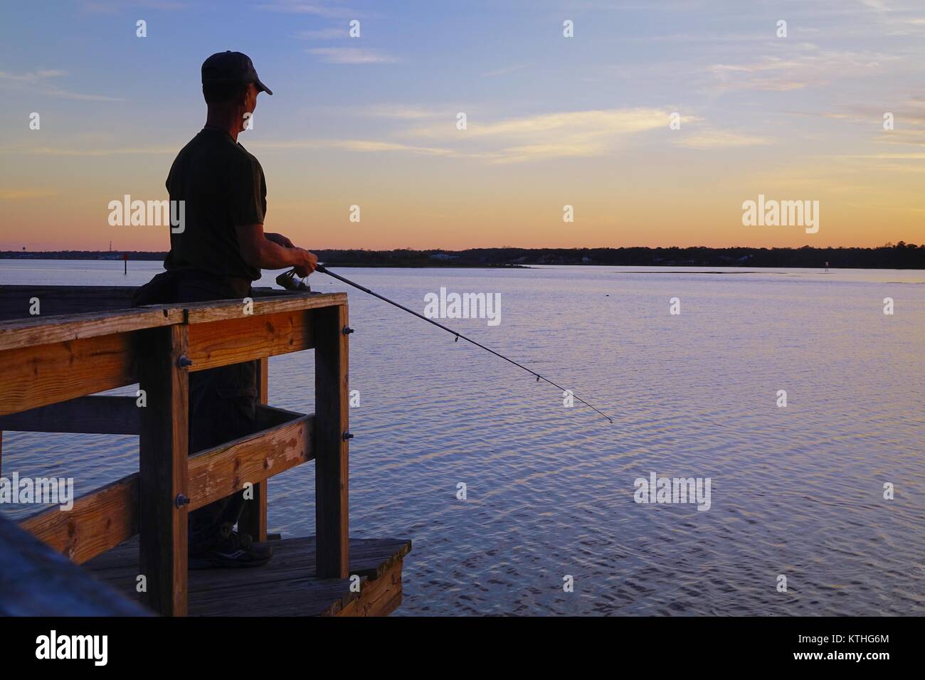 Young man fishing on dock hires stock photography and images Alamy