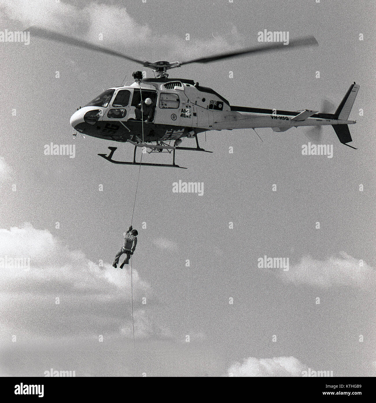 GOONDIWINDI, AUSTRALIA, CIRCA 1982: Unidentified crew member of the Queensland Government rescue helicopter abseils to the ground from helicopter, circa 1982 in Goondiwindi, Australia Stock Photo