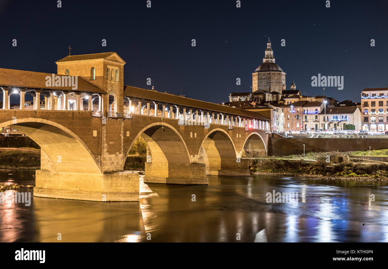 Night view of Pavia with Ponte Coperto and the river Ticino Stock Photo
