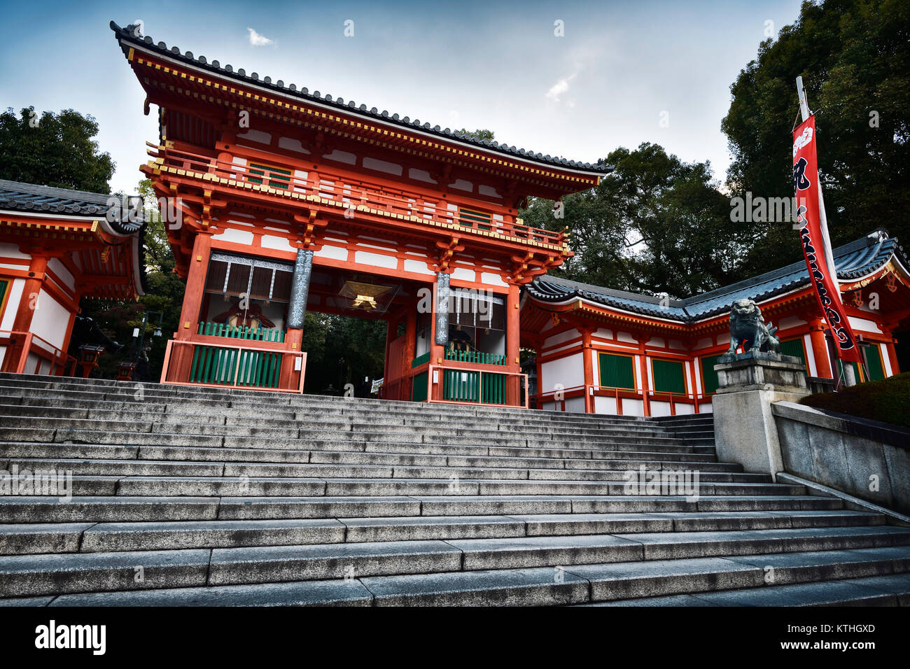 License and prints at MaximImages.com - Yasaka shrine, Yasaka-jinja bright orange main entrance gate low angle view in morning sunrise Gion, Kyoto, Ja Stock Photo