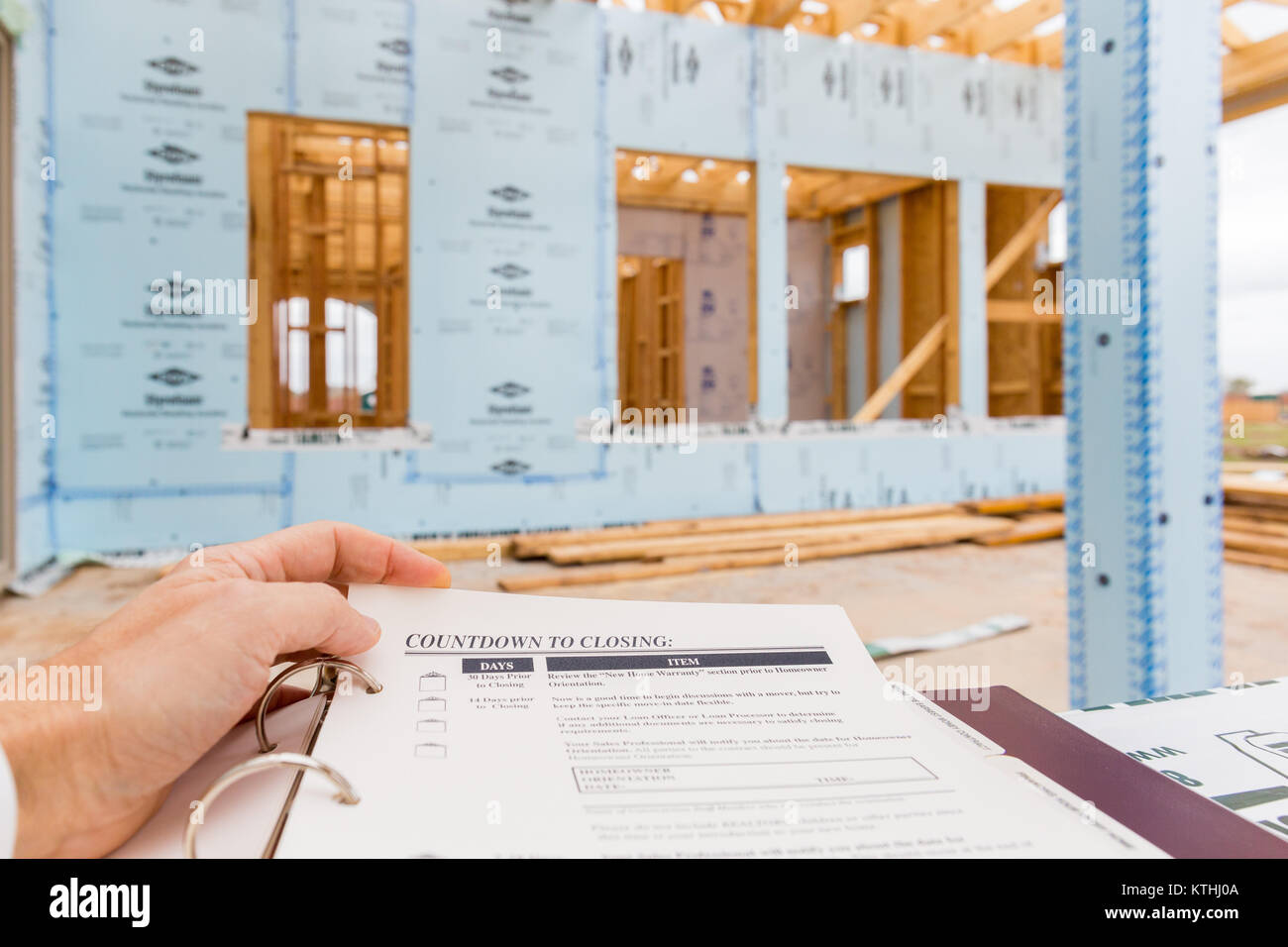 A new single family house under construction and new home closing documents folder Stock Photo