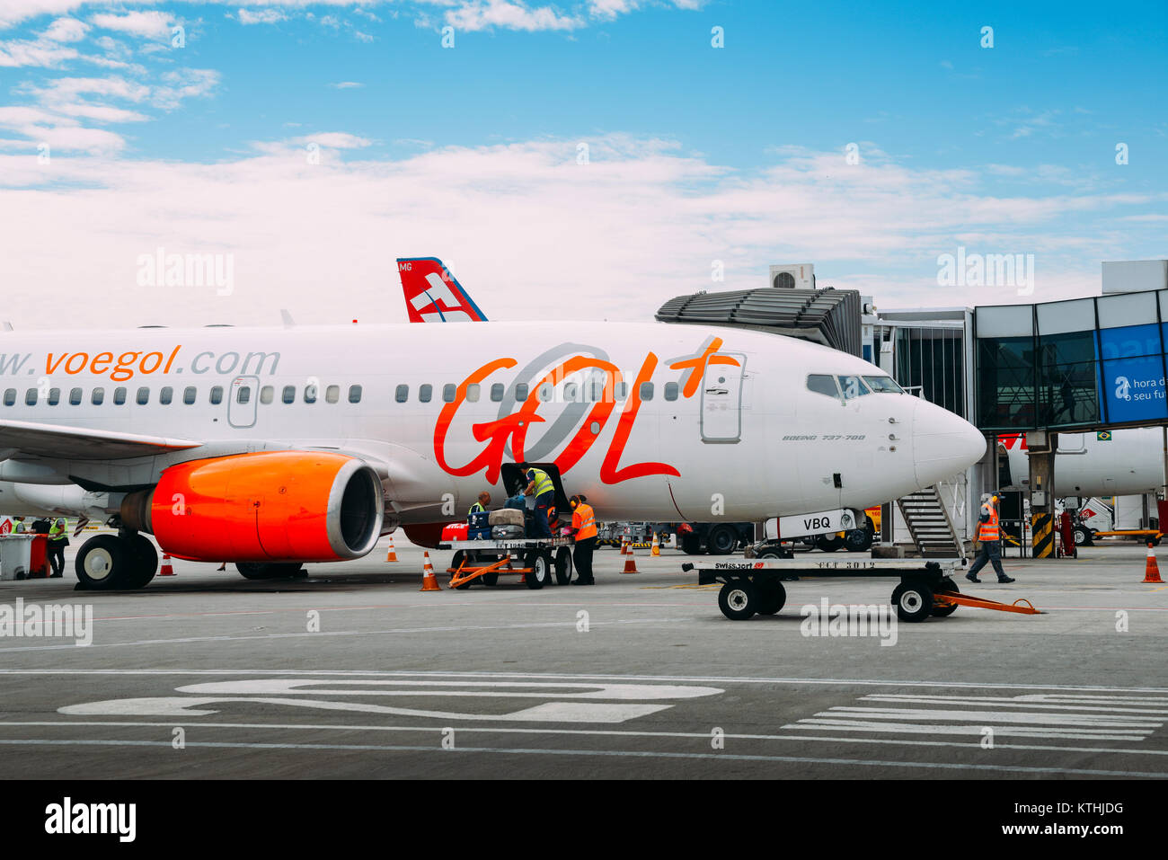 Airport workers at Rio de Janeiro's Santos Dumont Airport pick up passengers' luggage from a Gol airliner which services domestic flights Stock Photo