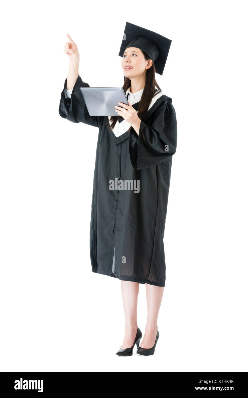 smiling pretty girl college student getting graduation diploma holding mobile digital tablet searching job information and using hand touching simulat Stock Photo