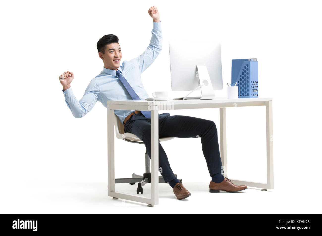 Young businessman cheering in office Stock Photo - Alamy