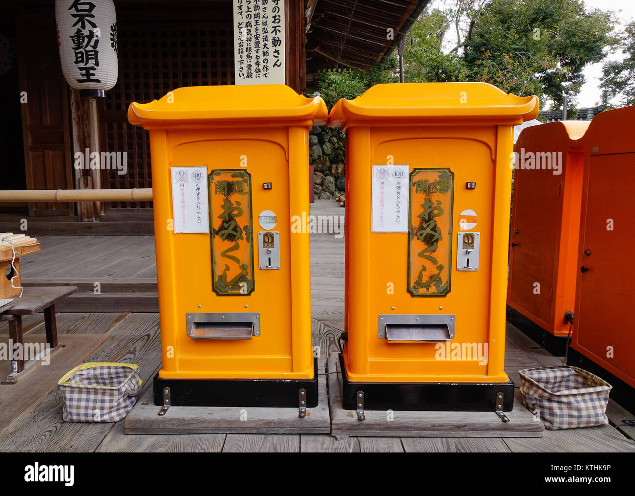 Kyoto, Japan - Dec 25, 2015. Yellow mail boxes at Kinkakuji Pagoda in Kyoto, Japan. Kinkakuji is a Zen temple in Kyoto whose top two floors are comple Stock Photo