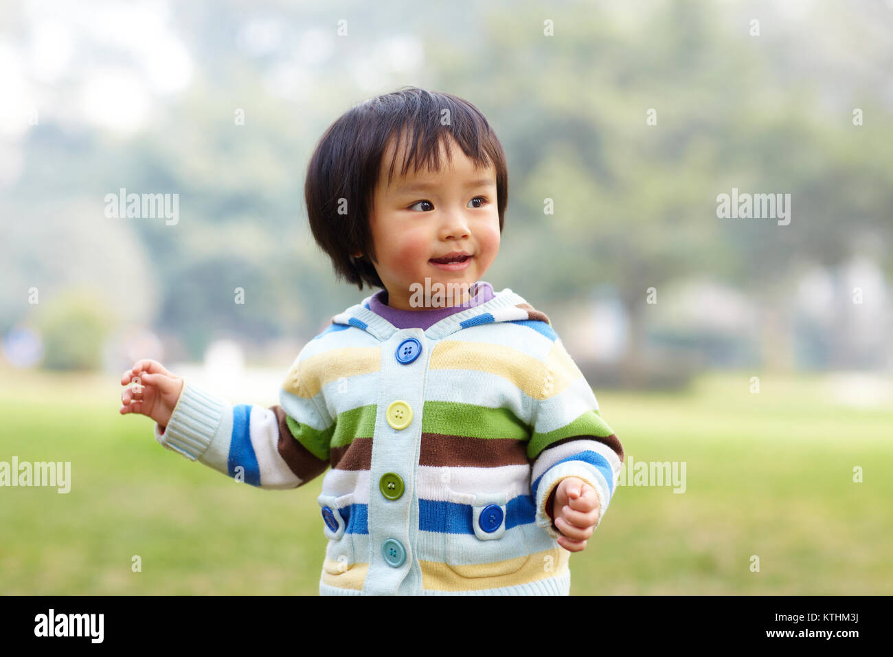 one happy little asian girl outdoor in the park Stock Photo - Alamy
