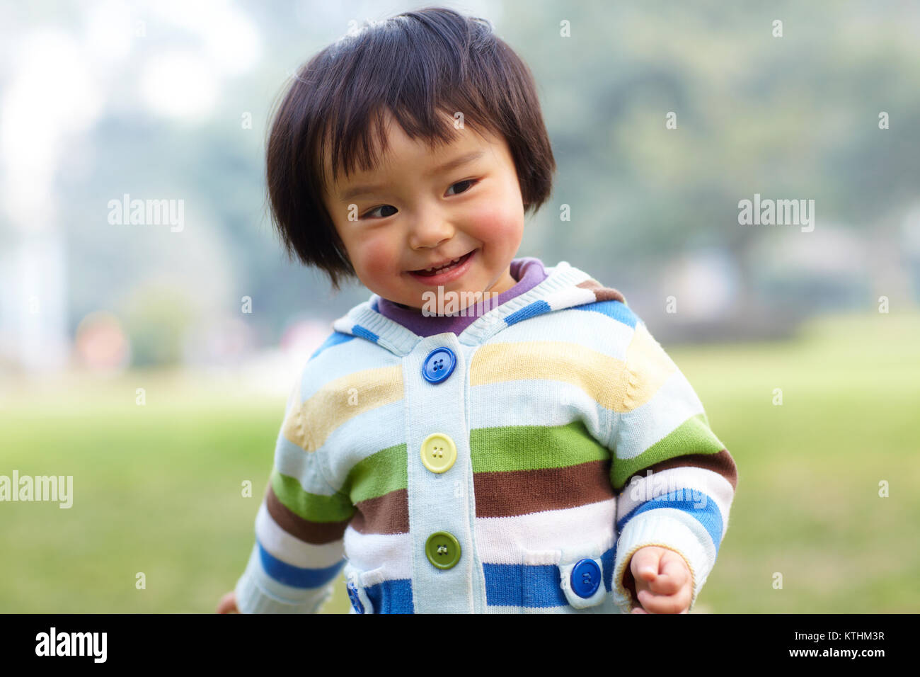 one happy little asian girl outdoor in the park Stock Photo - Alamy