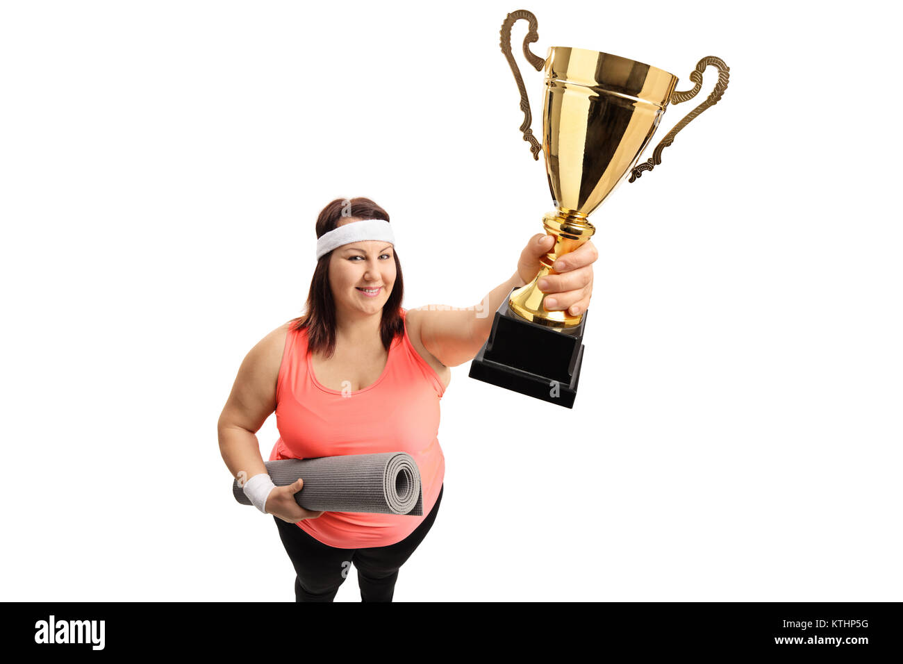 Overweight woman with an exercise mat and a golden trophy isolated on white background Stock Photo