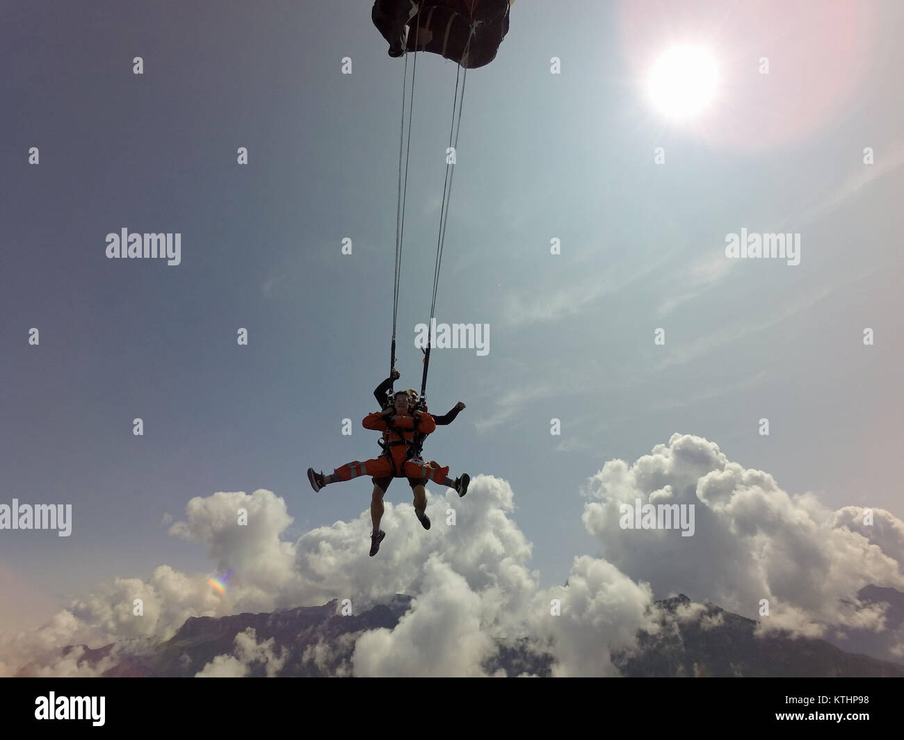 After a crazy tandem skydiving freefall, the instructor activated the parachute which stops the downward speed immediately. Stock Photo