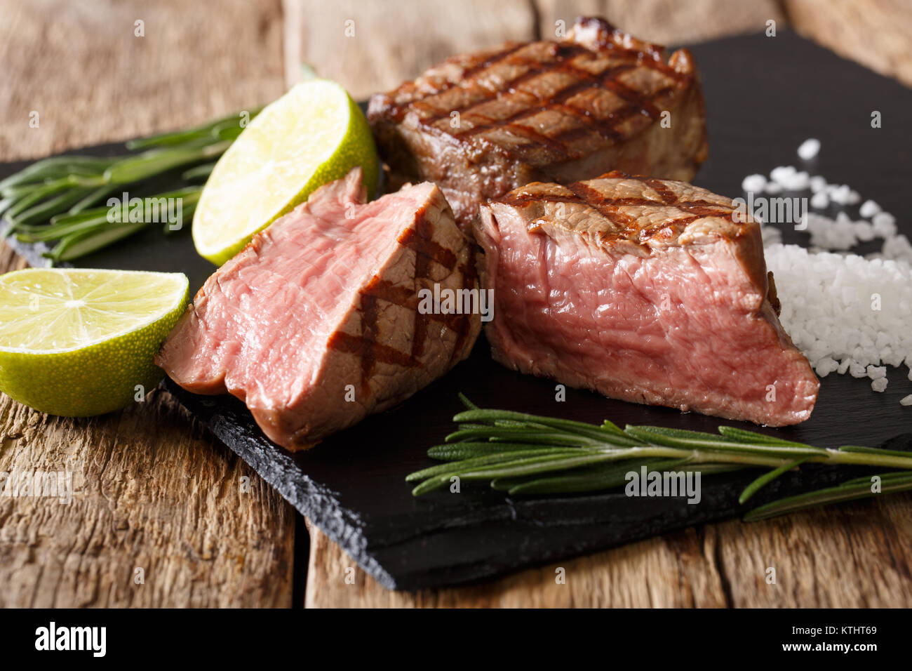 tasty fillet mignon beef steak close-up on a blackboard on the table. horizontal Stock Photo