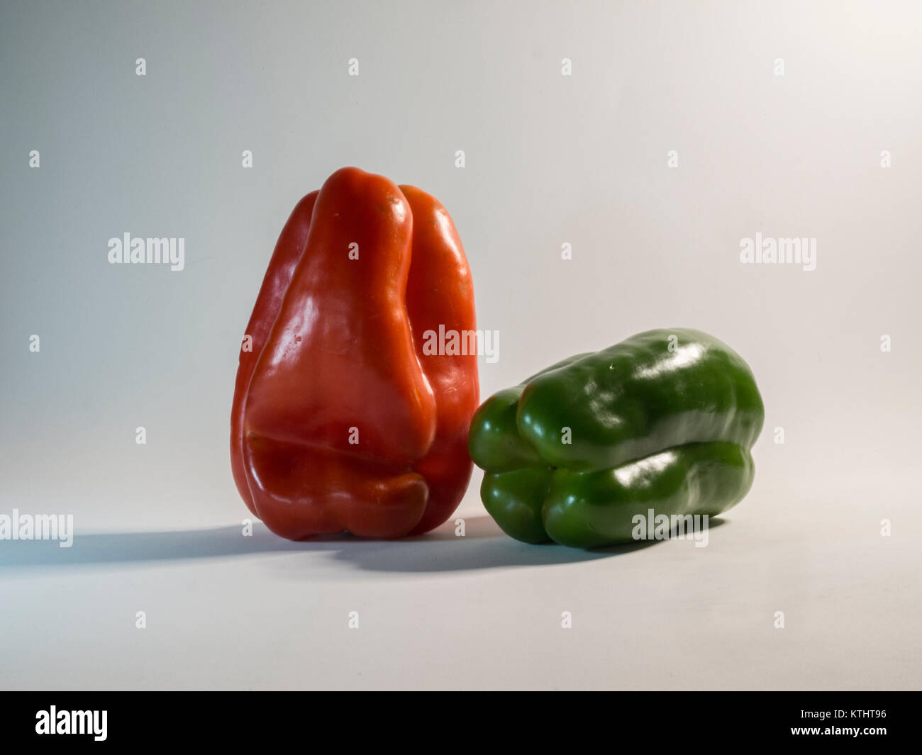 Red and green peppers on white background Stock Photo - Alamy